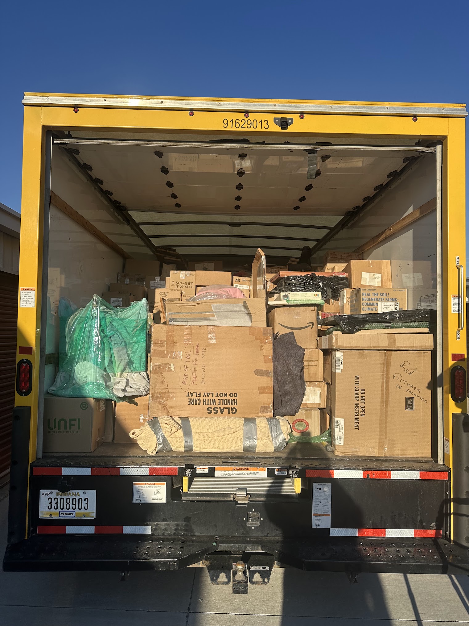 Local Des Moines movers loading household goods into a Midwest Moving Pros truck